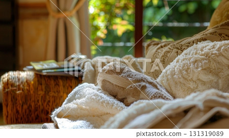 Fluffy folded towels resting on a couch with magazines in the background Fluffy folded towels resting on a couch with magazines in the background 131319089