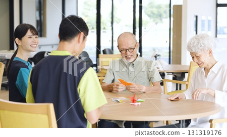 Elderly Asian people folding origami in a care facility Elderly Asian people folding origami in a care facility 131319176