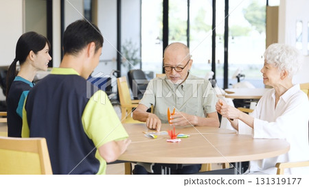 Elderly Asian people folding origami in a care facility Elderly Asian people folding origami in a care facility 131319177