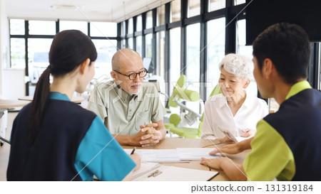 Elderly Asian people receiving explanation about nursing care facilities 131319184