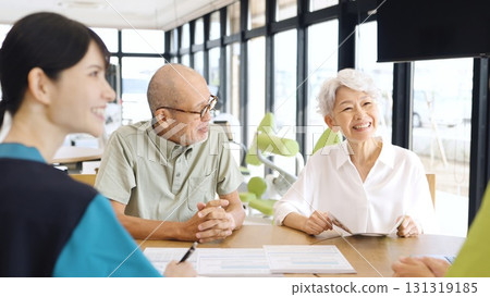 Elderly Asian people receiving explanation about nursing care facilities 131319185
