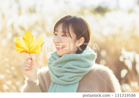 Young woman enjoying autumn leaves Young woman enjoying autumn leaves 131319586