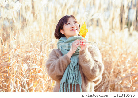 Young woman enjoying autumn leaves Young woman enjoying autumn leaves 131319589