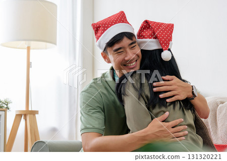 Christmas winter holiday season brings happy loving couple together, sharing pure love and warm hug at cozy home, celebrating memorable christmas day with genuine smiles, feeling festive and joyous. Christmas winter holiday season brings happy loving couple together, sharing pure love and warm hug at cozy home, celebrating memorable christmas day with genuine smiles, feeling festive and joyous. 131320221