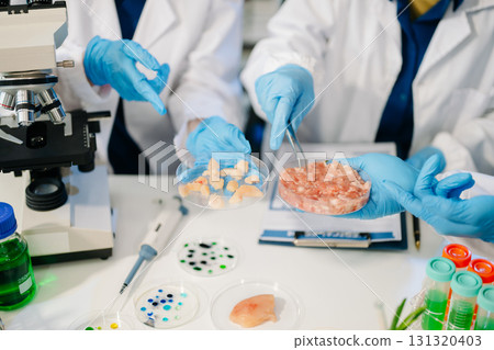 Team Asian scientists in a lab conducting food research using a microscope and lab equipment, showcasing innovation 131320403
