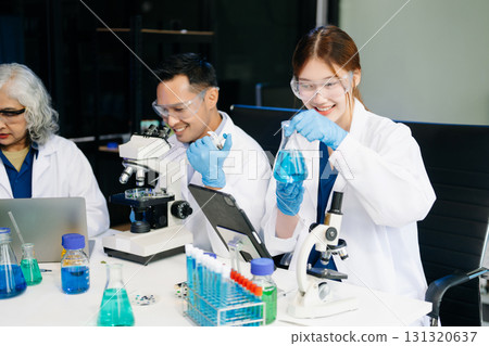 Dynamic science lab where a team of scientists collaborates on research, testing, and innovation 131320637