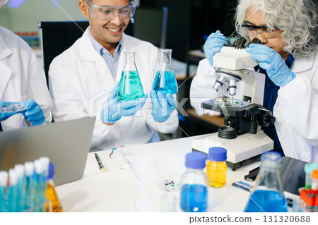 Dynamic science lab where a team of scientists collaborates on research, testing, and innovation 131320688