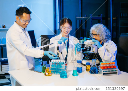 scientists conducting research investigations in a medical laboratory, a researcher in the foreground scientists conducting research investigations in a medical laboratory, a researcher in the foreground 131320697