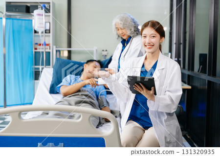 Hospital Ward Male and  Male Professional Asian Doctors Talk with a Patient, Give Health Care Advice, 131320935