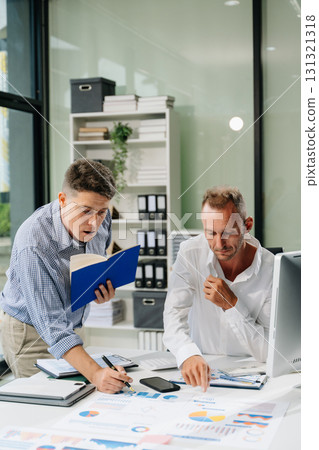 Professionals brainstorming and analyzing charts during a business meeting. Highlighting teamwork, Professionals brainstorming and analyzing charts during a business meeting. Highlighting teamwork, 131321318
