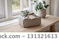 Eco-friendly present with a blank tag on a rustic wooden bench 131321613