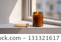 Cozy hygge concept with a scented candle in natural light 131321617