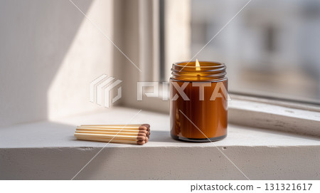 Cozy hygge concept with a scented candle in natural light Cozy hygge concept with a scented candle in natural light 131321617
