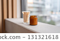 Lit aromatherapy candle in an amber jar for relaxation 131321618