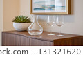 Modern home decor with an empty glass decanter and wine glasses 131321620