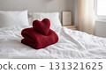 Red knitted heart on a cozy white bed for Valentine's Day 131321625