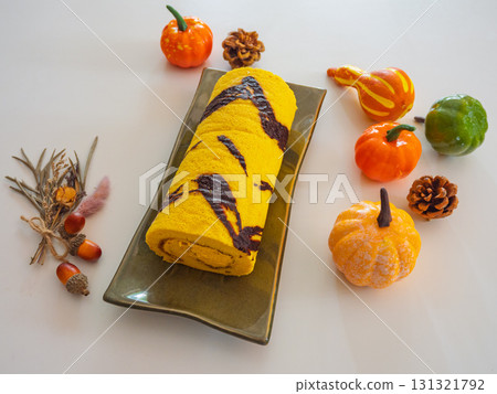 A heart-warming sweet treat featuring autumn pumpkin roll cake and Halloween colors A heart-warming sweet treat featuring autumn pumpkin roll cake and Halloween colors 131321792