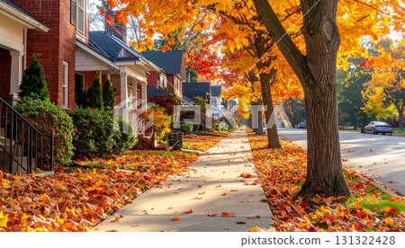 Residential street, fallen leaves on the sidewalk, warm and cozy autumn atmosphere Residential street, fallen leaves on the sidewalk, warm and cozy autumn atmosphere 131322428