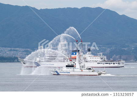 The Japan Coast Guard's patrol vessel Kotobiki is conducting a water-spraying demonstration in Hiroshima Bay, and the patrol vessel Itsukushima is conducting an experience voyage. 131323057