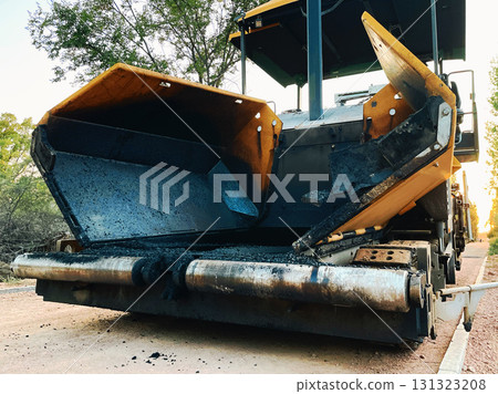 Asphalt paving machine on construction site 131323208
