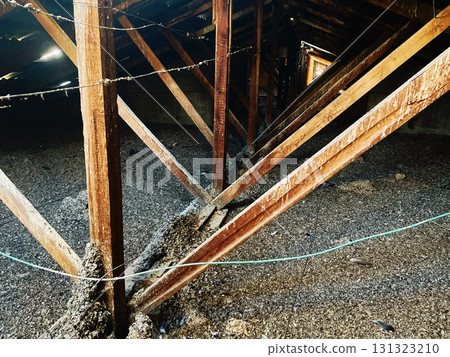 Old attic with wooden beams and debris Old attic with wooden beams and debris 131323210