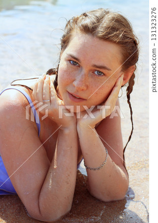 Woman relaxing on sandy beach 131323276