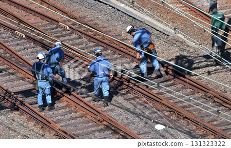 Track maintenance and inspection work: Walking along the tracks and visually checking for distortions and damage to the rails Track maintenance and inspection work: Walking along the tracks and visually checking for distortions and damage to the rails 131323322