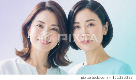 Portraits of women with the image of sisters or twins. Image material suitable for beauty and hair care advertisements. 131323352
