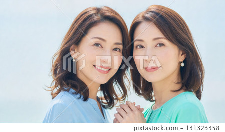 Portraits of women with the image of sisters or twins. Image material suitable for beauty and hair care advertisements. 131323358