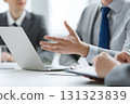 The hands of a male businessman making a proposal while using a laptop computer at a meeting 131323839