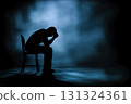 Silhouette of a man looking down in the dark. Loneliness, despair, sadness, depression, mental stress 131324361