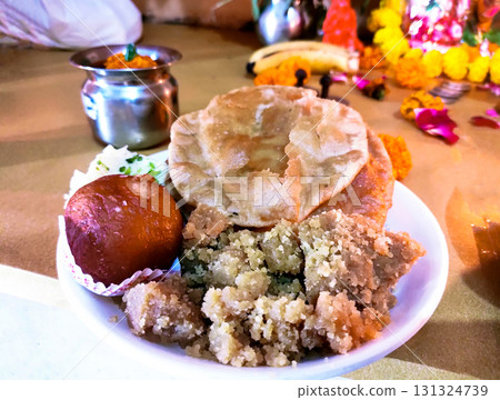 Traditional Indian Prasad Offering with Sweets and Puri Traditional Indian Prasad Offering with Sweets and Puri 131324739