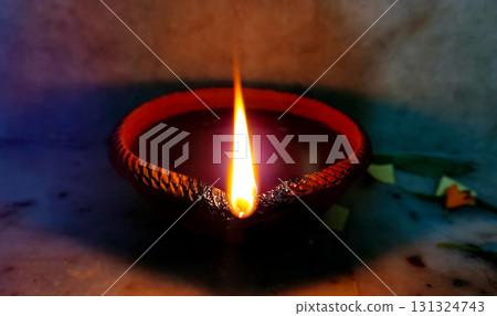 Single Clay Oil Lamp Glowing in Darkness Single Clay Oil Lamp Glowing in Darkness 131324743