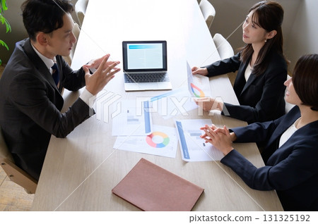 Men and women having a meeting in an office taken from above 131325192