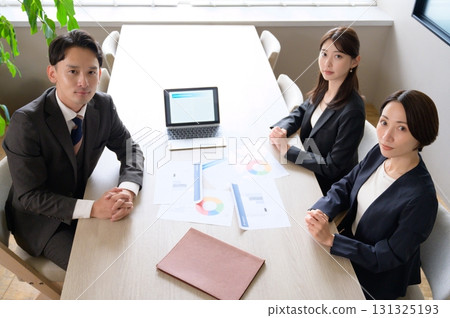 Men and women having a meeting in an office taken from above 131325193