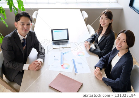 Men and women having a meeting in an office taken from above 131325194
