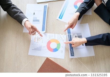 Aerial view of the hands of a man and woman having a meeting in an office 131325195