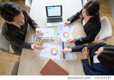 Men and women having a meeting in an office taken from above Men and women having a meeting in an office taken from above 131325197