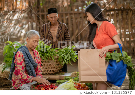 A colorful local market featuring women and elderly vendors actively engaged in community life A colorful local market featuring women and elderly vendors actively engaged in community life 131325577