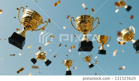 A collection of gold trophies floats in the air, representing educational success and the pursuit of learning 131325620