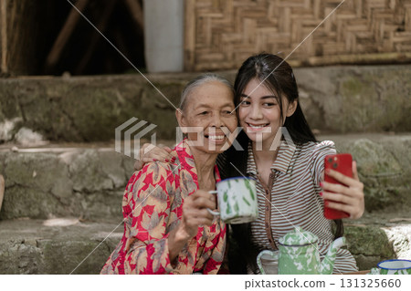 Generational Bonding: A Heartwarming Moment Between a Grandmother and Granddaughter 131325660