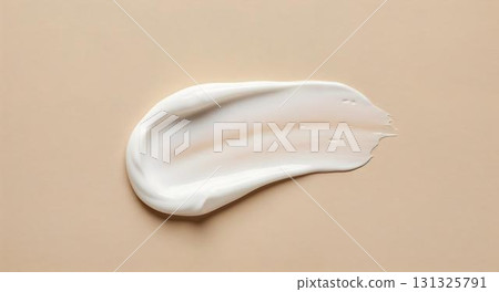 A white cream set on a beige background, highlighting its use in skincare and self-care routines 131325791