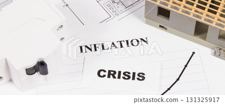 Inscriptions crisis and inflation with electric fuse, small house under construction 131325917