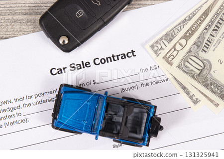 Car sale contract, dollar banknotes, blue toy car and black key. Sales, purchases of vehicle 131325941