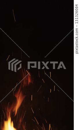 fire flames of campfire with sparks over black background, for overlay 131326084