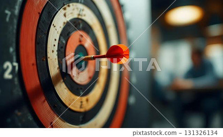 A dartboard with a dart shows the themes of success, strategy, and achievement in problem-solving 131326134