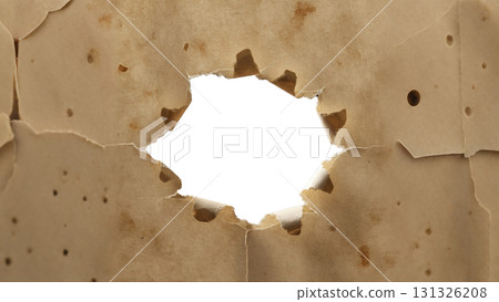 Hole isolate in vintage paper creates a unique abstract background with torn edges. A great place to insert text or an object in the center. Hole isolate in vintage paper creates a unique abstract background with torn edges. A great place to insert text or an object in the center. 131326208