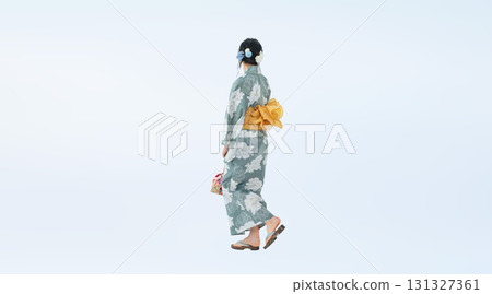 A full-body photo of a teenage woman wearing a yukata walking from behind A full-body photo of a teenage woman wearing a yukata walking from behind 131327361