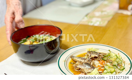 Elderly people eating and placing hands 131327384