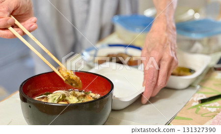 Hands of an elderly woman preparing a meal Hands of an elderly woman preparing a meal 131327390